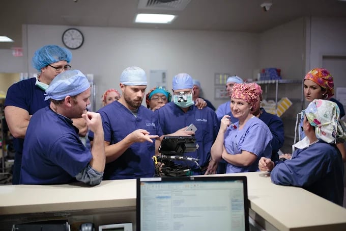 Medical team discussing patient case in hospital operating room