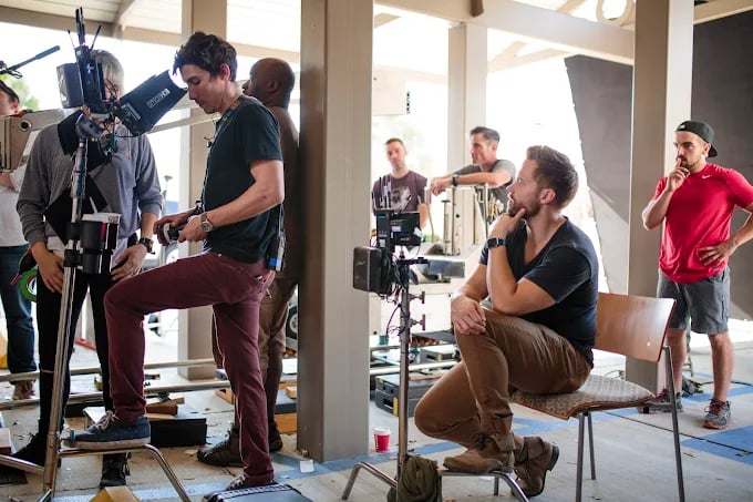 Film crew working on set with cameras and lighting equipment