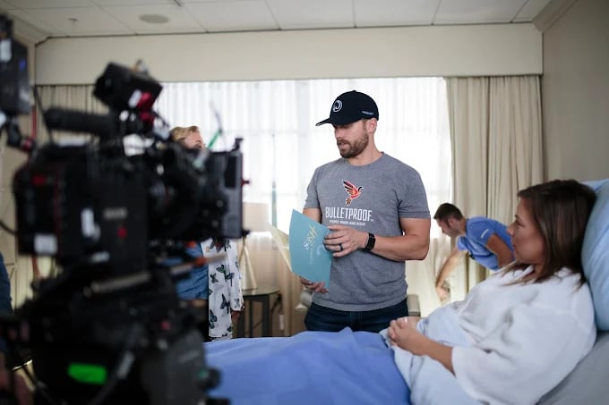 Behind-the-scenes film set with camera and medical scene crew